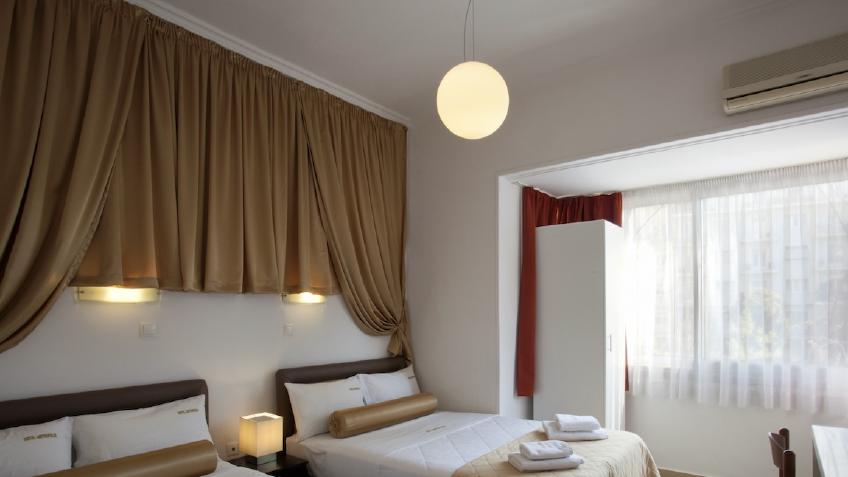 Family room with 2 double beds and view of the metropolis square.jpg