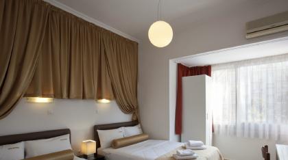 Family room with 2 double beds and view of the metropolis square.jpg