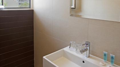 Superior double room bathroom with acropolis view.jpg